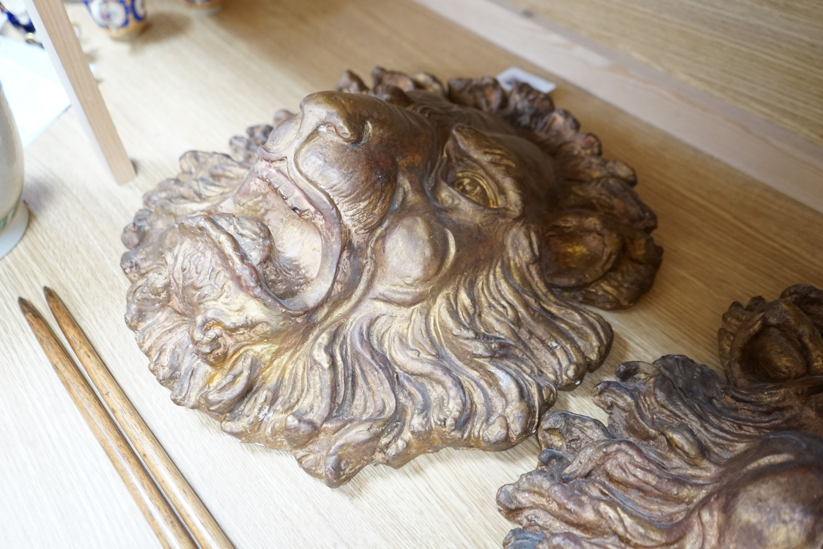 A pair of large decorative gilt plaster lion masks, 42cm
